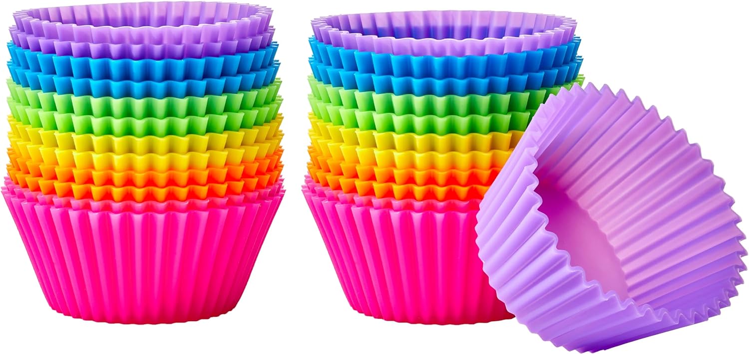 Amazon Basics silicone baking cups in assorted colors on a muffin pan